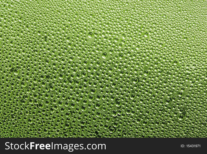 Texture of water drop on glass in Green