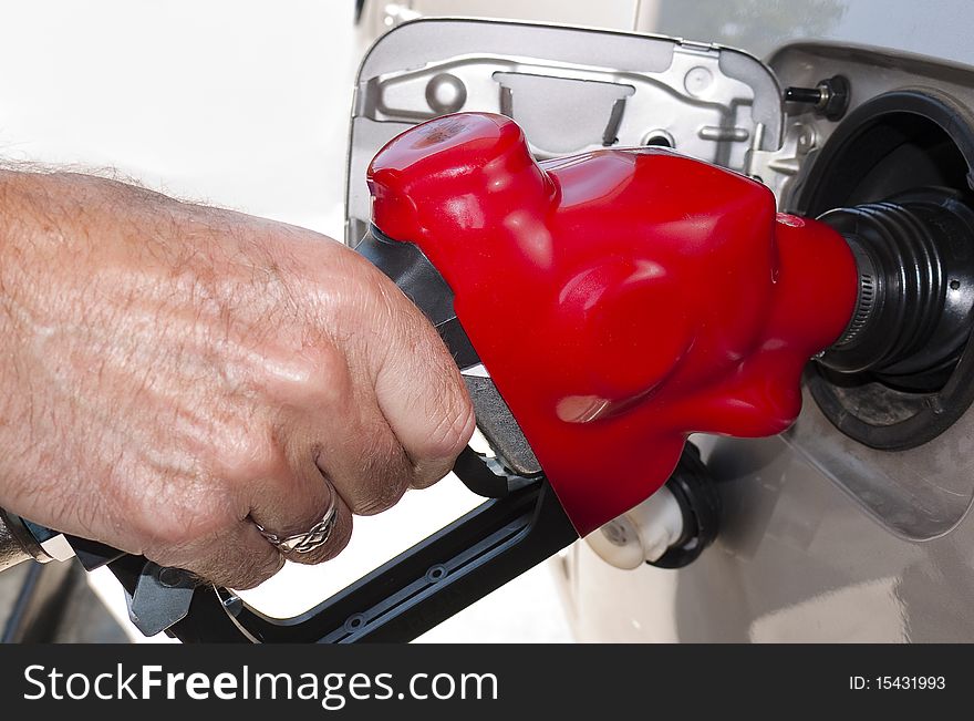 Close-up of hand refueling at gas pump. Close-up of hand refueling at gas pump