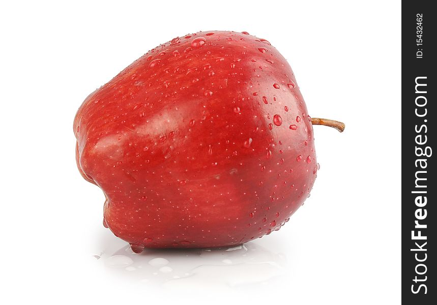 Fresh apple on isolated white background. Organic, healthy red delicious apple has drops of water on it, stem and slight shadow.