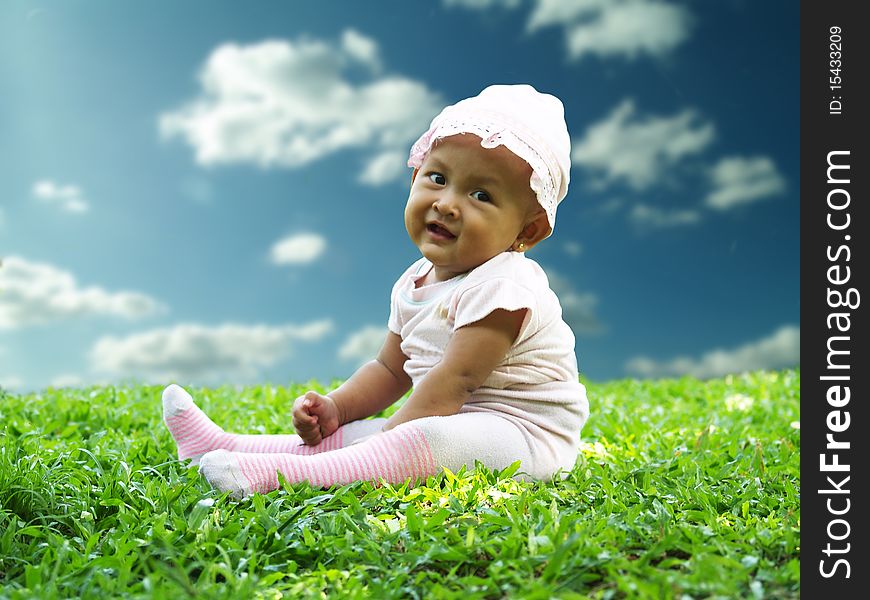 Happy face asian smiling toddler in green grass field. Happy face asian smiling toddler in green grass field.