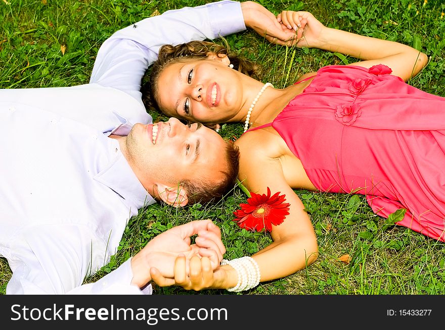 Young couple resting on the grass. Young couple resting on the grass