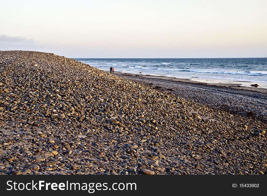 Evening walk on a pebbly beach