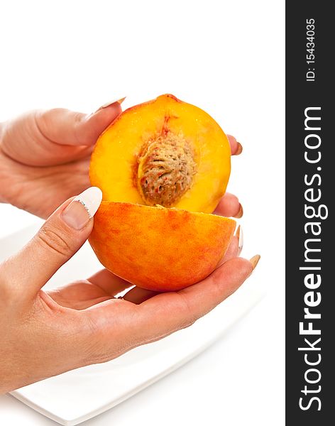 One peach in beautiful female hands. Isolated on white. One peach in beautiful female hands. Isolated on white
