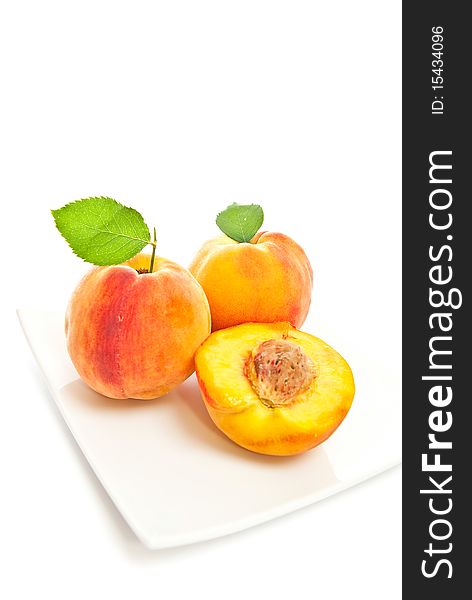 Three peaches on a white background. Vertical shot