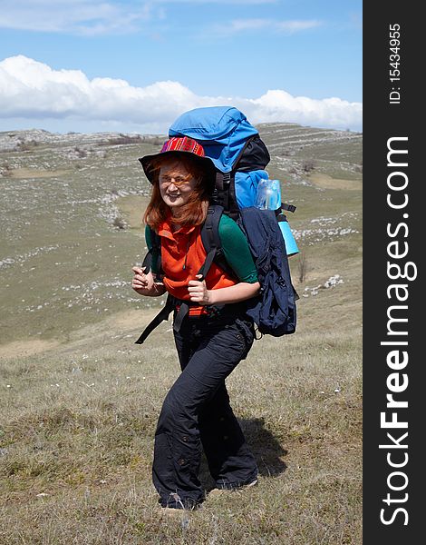 Red haired girl with blue backpack