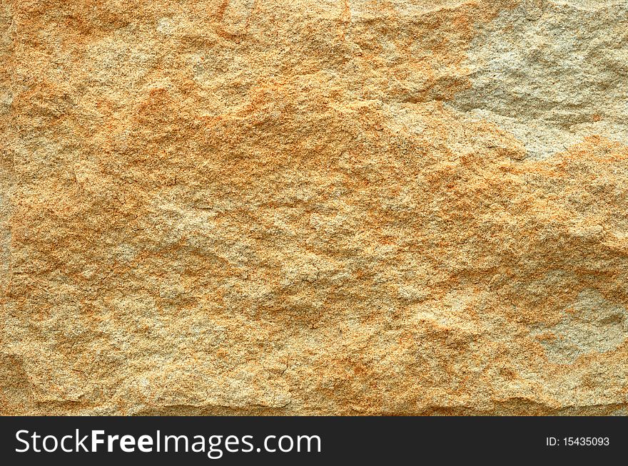 Abstract background from yellow stone wall