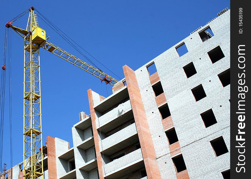 Building - the crane near the under construction brick house