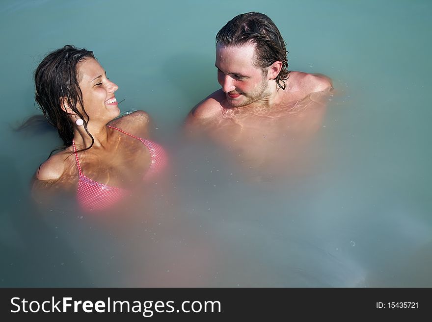 Man and woman have good time in open water on resort. Man and woman have good time in open water on resort