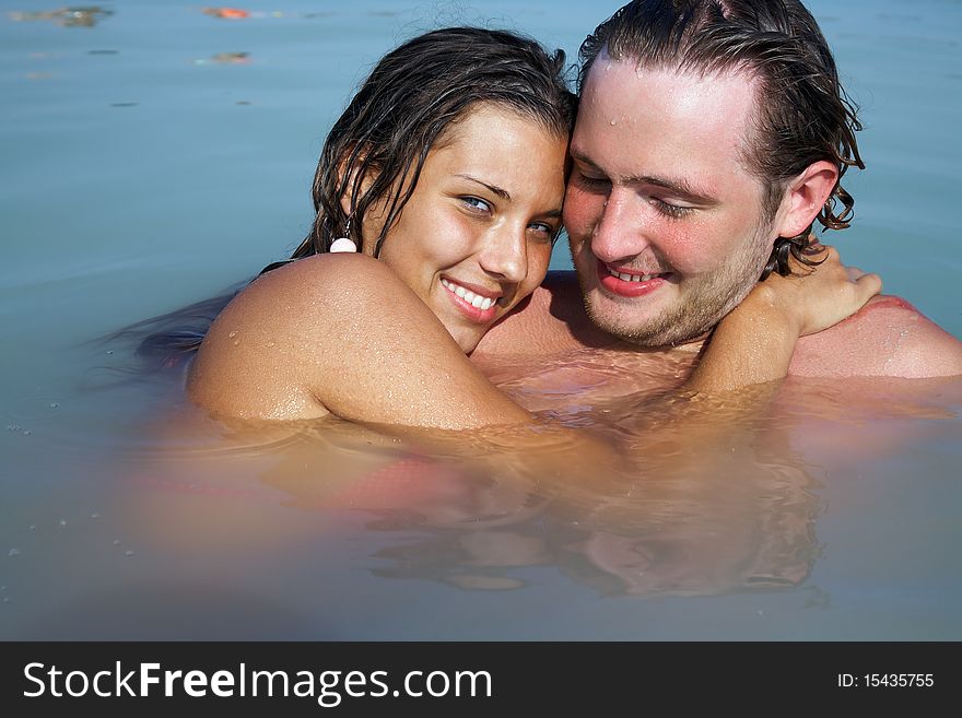 Photo of young man and woman together in open water on resort. Photo of young man and woman together in open water on resort