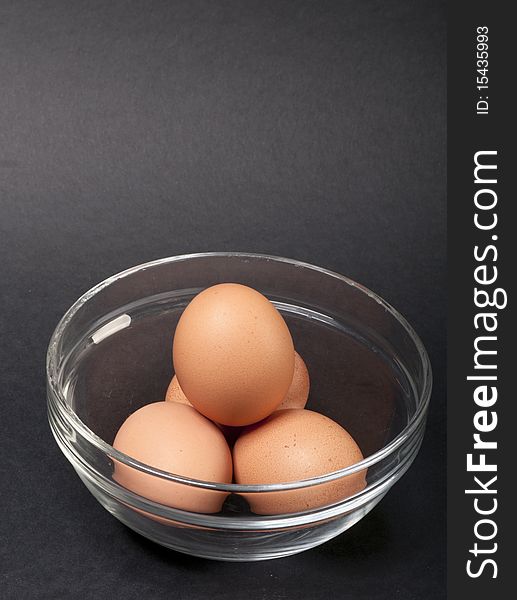 Three boiled eggs in a glass bowl