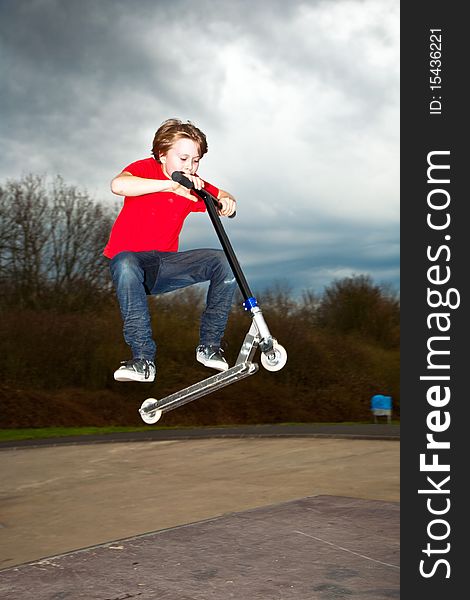 Boy with scooter at the skate parc