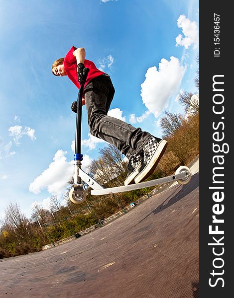 Boy with scooter at the skate parc