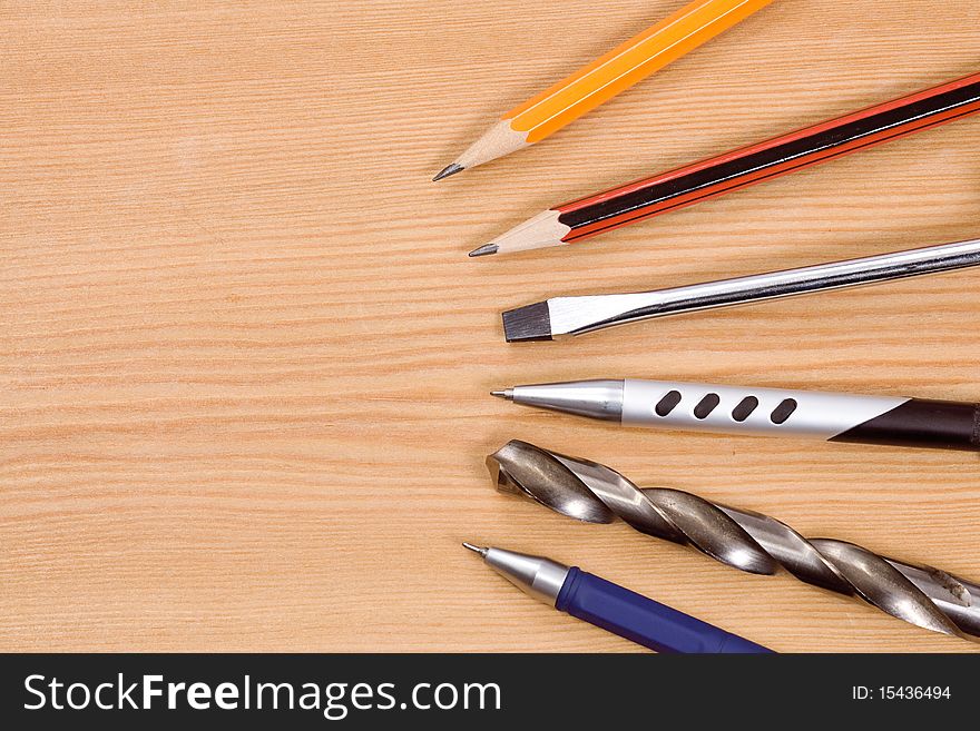 Tools, pencil and pens at table