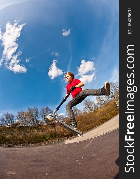 Boy with scooter at the skate parc