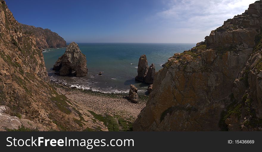 A small and deserted boulder beach next to Cabo da Roca. Sintra, Portugal. A small and deserted boulder beach next to Cabo da Roca. Sintra, Portugal