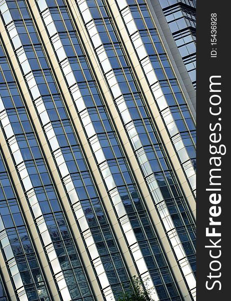 Tilted building feature with sparkling glass curtain wall