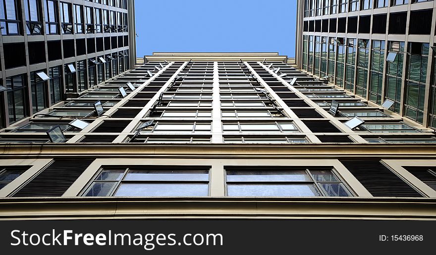 Tilted building feature with sparkling glass curtain wall