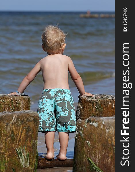 Child, water and fun. Baby boy have fun. Two years old baby boy on the beach. Child, water and fun. Baby boy have fun. Two years old baby boy on the beach.