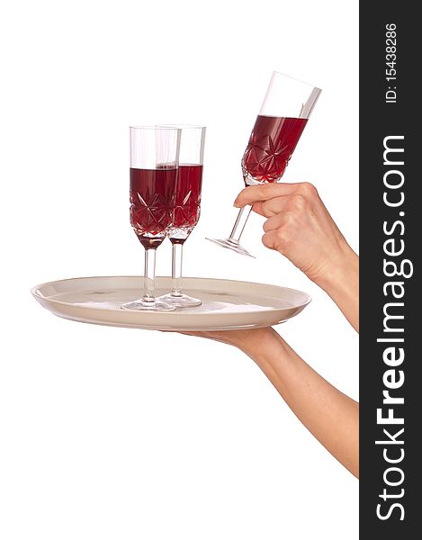 A waiter takes a glass of champagne from a tray with three glasses. A waiter takes a glass of champagne from a tray with three glasses