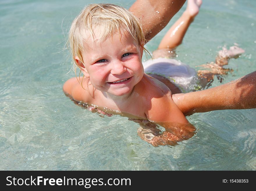 Portrait of happy baby swimming