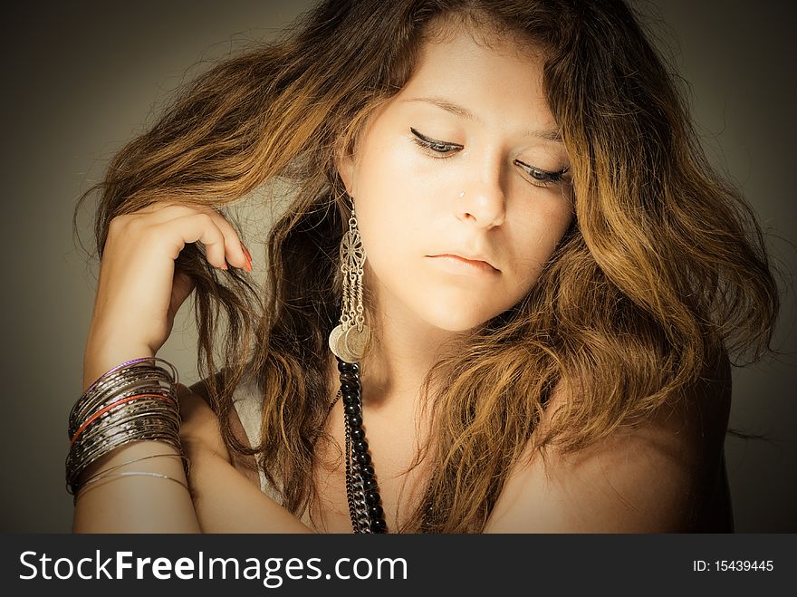 Gently young beautiful woman touching her hair. Gently young beautiful woman touching her hair