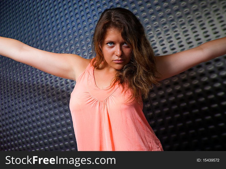 Young woman in pink dress spreading arms. Young woman in pink dress spreading arms