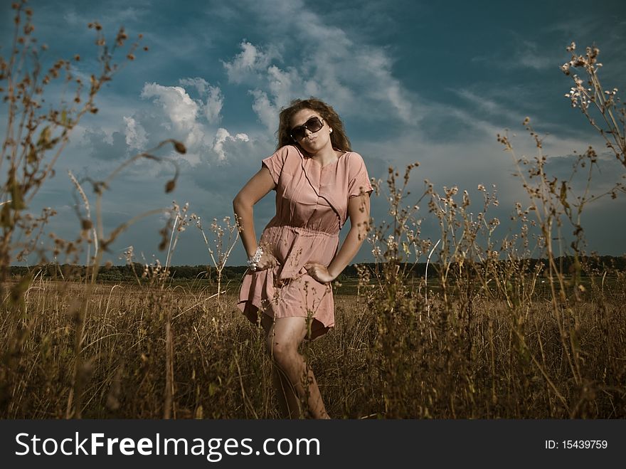 Young woman in sunglasses at summer meadow plants. Young woman in sunglasses at summer meadow plants