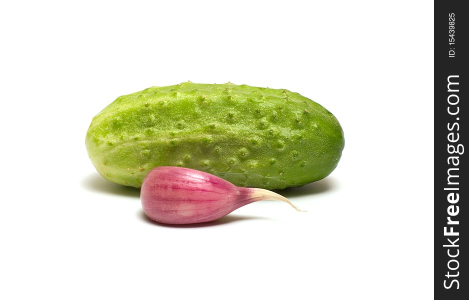 Cucumber and garlic clove on a white background. Cucumber and garlic clove on a white background.