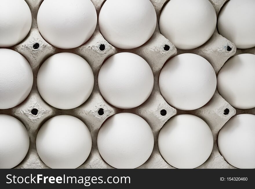Pack of white eggs close-up. The view from the top. Pack of white eggs close-up. The view from the top