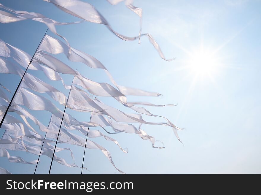 Triangular white banner against the blue sky