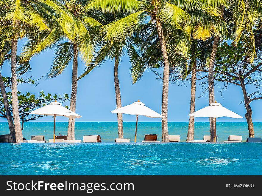 Umbrella And Chair Around Swimming Pool In Hotel Resort Neary Sea Ocean Beach For Vacation