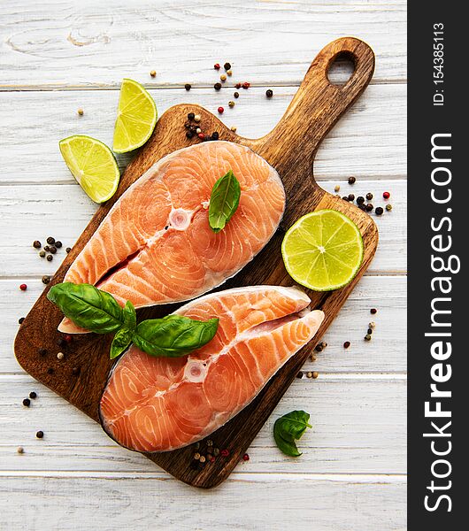 Raw salmon steaks and ingredients on a old wooden table