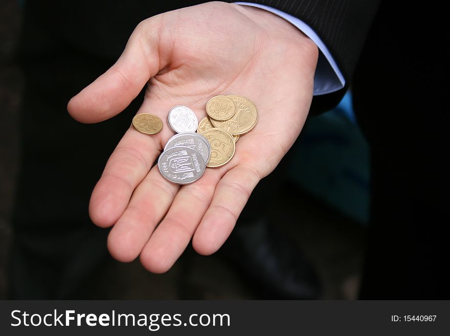 Macro view of different coins in a man's hand. Macro view of different coins in a man's hand