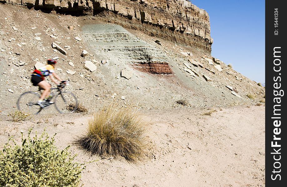 A biker rides through the scenery along the Rim Rock Drive in Colorado National Park. A biker rides through the scenery along the Rim Rock Drive in Colorado National Park.