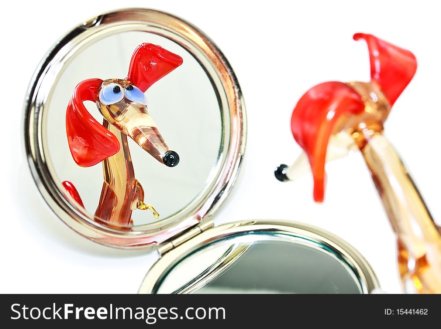 Glass dachshund looking in the mirror