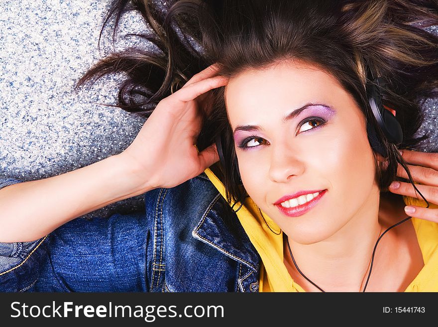 Lovely cheerful teenage girl listening a music. Lovely cheerful teenage girl listening a music