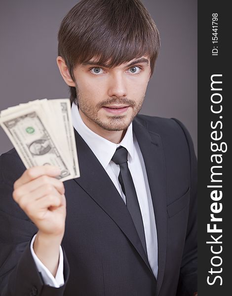 Young businessman holding many one dollars notes in his hand. Young businessman holding many one dollars notes in his hand