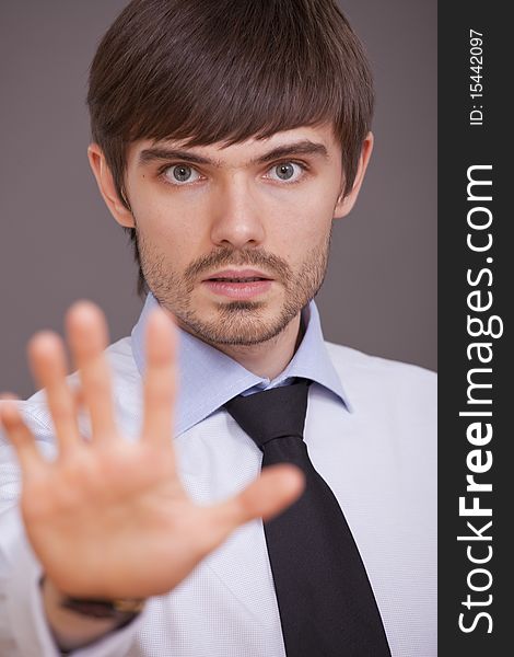 Businessman stretching out his hand in a stop sign