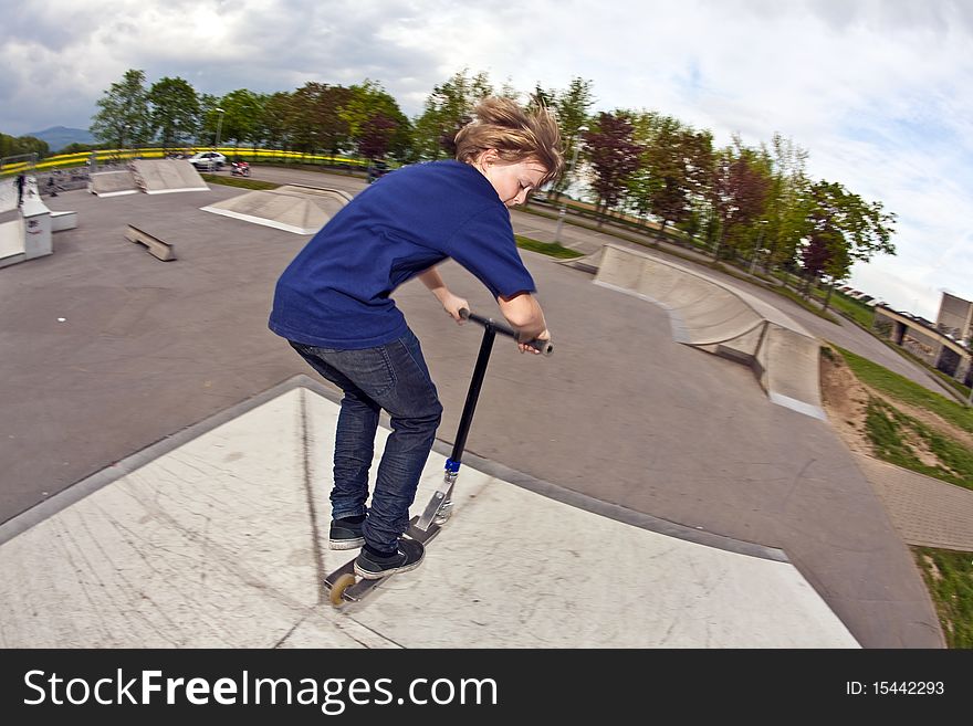 Young boy going airborne with his scooter. Young boy going airborne with his scooter