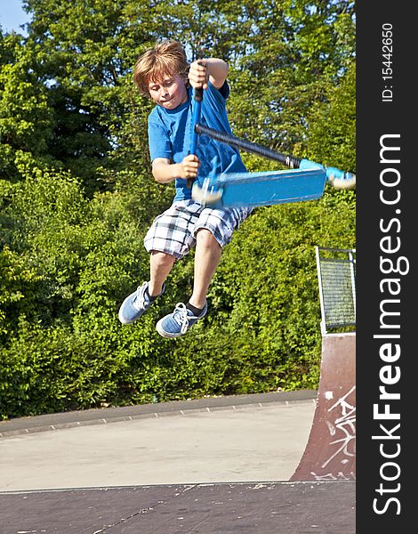 Young Boy Going Airborne With A Scooter