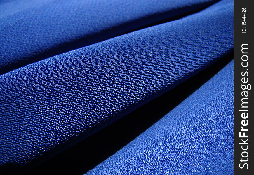 Macro detail texture royal blue crepe fabric diagonally. Macro detail texture royal blue crepe fabric diagonally