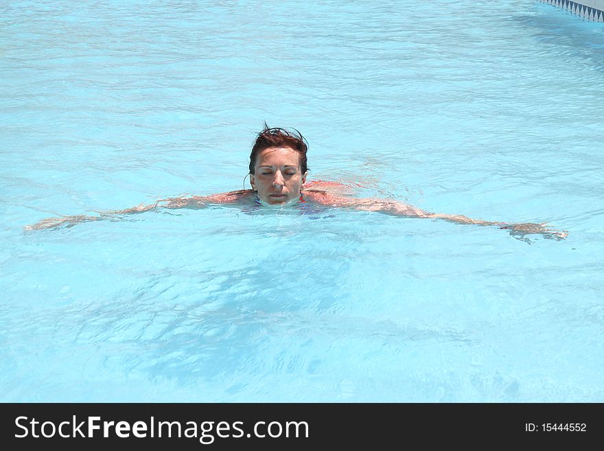 Woman Swimming And Relaxing In A Pool