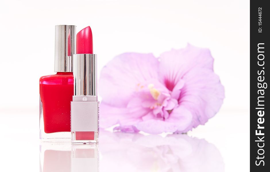 Lipstick and Nail Polish with Flower in Background. Lipstick and Nail Polish with Flower in Background