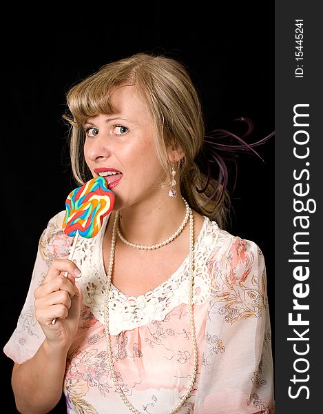 Women licking lollypop, vintage stile, black background. Women licking lollypop, vintage stile, black background