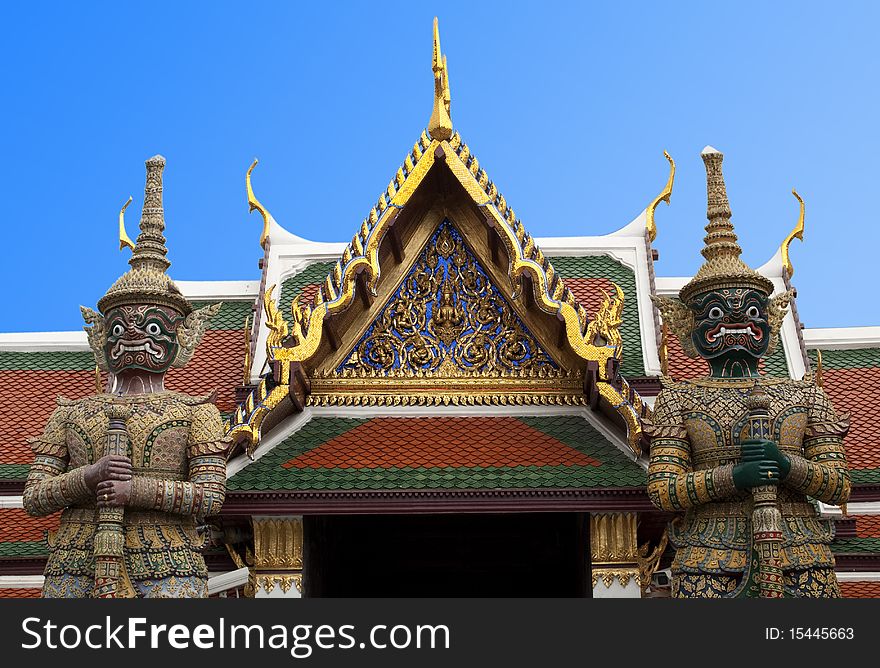 The giant guardians with anger face at The Emerald Buddha Temple in Bangkok, Thailand. The giant guardians with anger face at The Emerald Buddha Temple in Bangkok, Thailand.