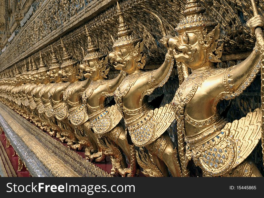 The golden statues of the creature of myth of Thailand at The Emerald Buddha Temple in Bangkok. The golden statues of the creature of myth of Thailand at The Emerald Buddha Temple in Bangkok.