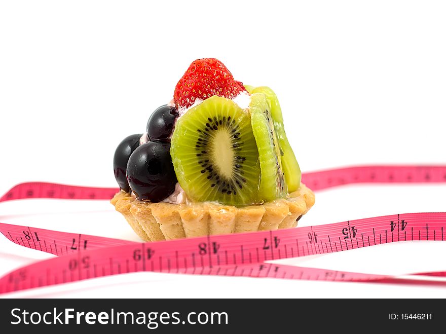 A delicious fruit tart with measuring tape