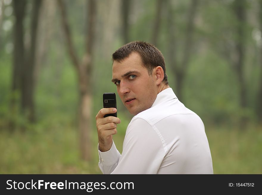 Portrait of young attractive man calling by phone