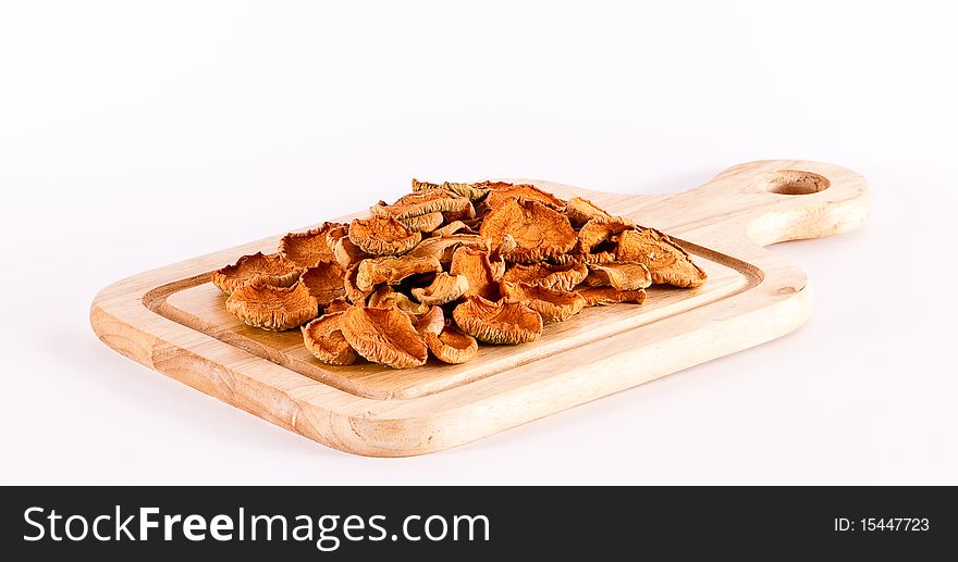 Dried apples on wooden cutting board