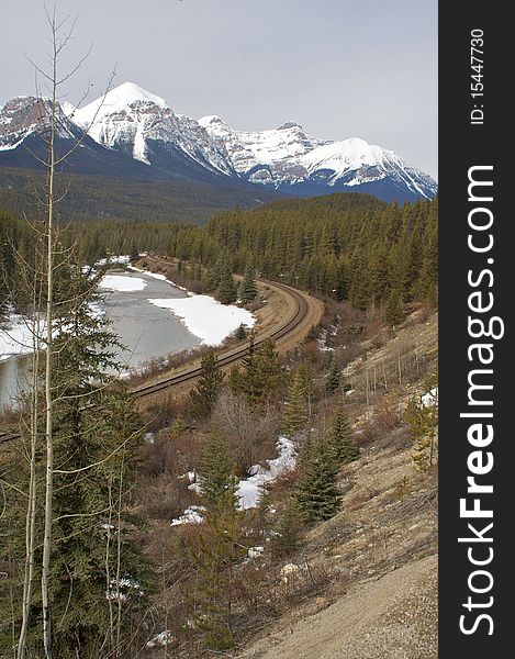 A mountain railway next to a river in Banff national park. A mountain railway next to a river in Banff national park.